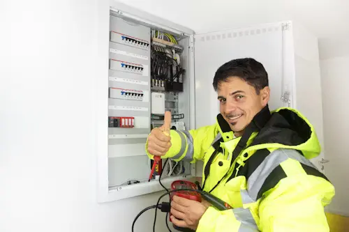 Licensed electrician in Al Ain performing a DB box safety inspection and electrical maintenance for a residential villa.