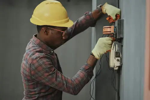 Licensed electrician in Al Ain repairing electrical panel safely